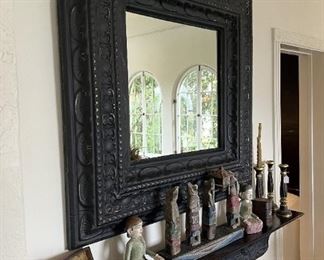 A very pretty wall mirror, candlesticks, and figurines are here.