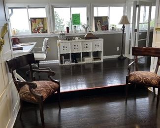 This overview picture shows a pair of chairs in the foreground, as well as a storage cabinet in the central background.