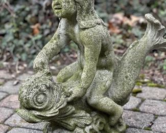 Garden statuary, boy riding on fish.