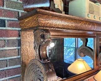 Oak mantel mirror with carved gargoyle brackets.