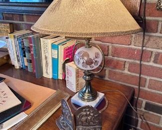 Pine cone detail on table lamp, bronze bookends.