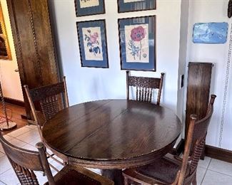 Paw foot round dining table & press back oak chairs.