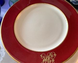 Set of royal red dinner plates with gold band.