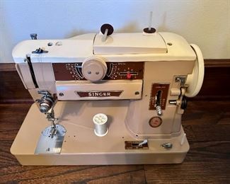 Vintage all metal Singer sewing machine, case and attachments.