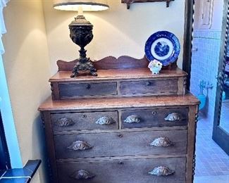 7-drawer Victorian wood dresser with carved pulls.