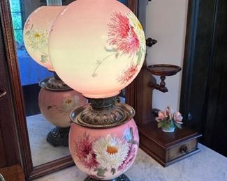 Painted floral glass globe lamp.