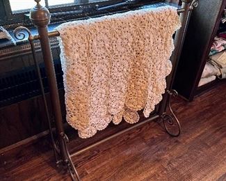 Bed coverlet & metal quilt stand.