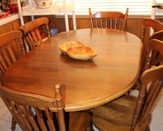 kitchen ding table, shown with two 12" leaves; 42" round without the leaves. Six chairs.