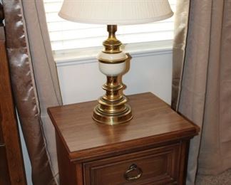 one of a pair of nightstands and table lamps