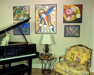 Yamaha baby grand, with ivory-tickling cat, five original oils on canvas, by Amy Dandy, Asian bronze table lamp, metal side table, w/mosaic tile top, one of a pair of bergere chairs and the fabby Persian Bakhtiari rug. A sweet story and bio of May Dandy. The owner and Amy were very close friends, brought together during an unfortunate tragedy and friends for life. The owner became an avid collector of her works and this is the largest display of her artwork, outside of her studio.