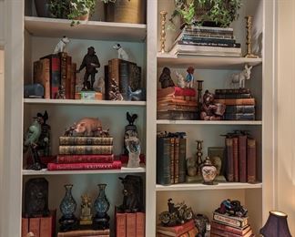 Living room bookcases filled with vintage and antique leather-bound books, Asian porcelains, cloisonné and vintage cast iron collection.