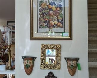 Framed/matted fruit still life, pair of vintage Roseville wall pockets, cast iron door knocker and small. gold wall mirror.
