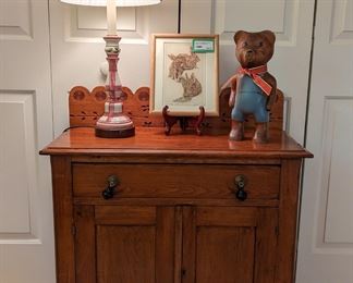 Antique wooden chest, w/backsplash, glazed ceramic table lamp, nicely framed/matted "Three Rabbits", by Judith Hall.