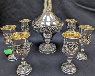 Solid Sterling Silver grape motif ewer, w/Stopper, weighs 682 gm., w/matching set of six sterling silver goblets, weighing 901 gm.