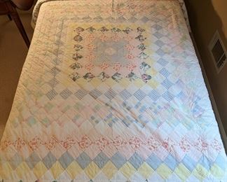 PAIR of hand-stitched, pastel twin size cotton quilts.