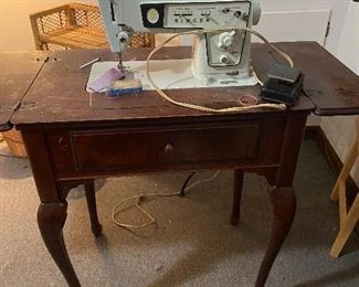 Vintage Kenmore sewing machine in cabinet