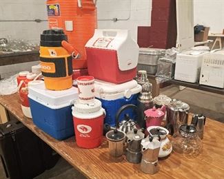 Espresso and tea pots.  Vintage corel ware coffee pot. Thermos and ice chests of various sizes. 