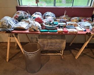 Sewing, crochet and macrame supplies.  Bingo drum below table. 