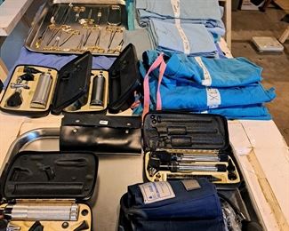 Medical scrubs, ear examining tools, great scissors, blood pressure cuff.