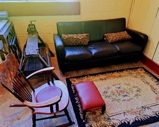 Leather couch from Pottery Barn, hooked rug, antique workbench with vice from Airbnb. 