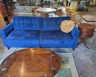 Walmart sofa bed (newish but needs repair), beautiful antique drum table.  Large hanging swing in background on floor. 