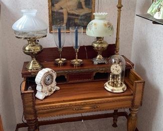 Antique desk decorated with antique clocks and lamps