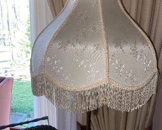 Great fringed lamp shades on numerous floor  lamps 