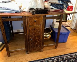 Antique gateleg table with center drawers and cabinets on both sides