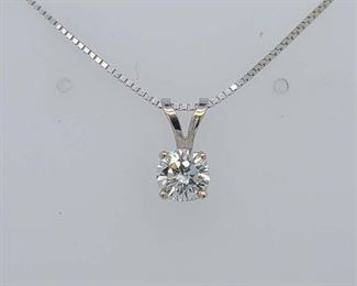 Very good condition. From Calhoun's: "One lady's 14kt white gold 4-prong solitaire pendant containing one round brilliant-cut diamond measuring 5.65x3.33mm and weighing approximately .63cts with a color of I and clarity of SI1. Note: Pendant is hanging on a 14kt white gold box chain measuring .90mm wide and 20" in length. Metal weight: 1.96 DWTs." 
