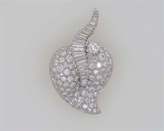 Very good condition. From Calhoun's: "LDs white heart brooch/pendant, not CT or trademarked. Estimated to be platinum. Set w/one .42ct RBC DIA, Four .01ct, Two .02ct, Three .025ct, One .03ct, Three .035ct, One .05ct, Two .07ct, Five .08ct, Three .12ct, Two .16ct, One .18ct, One .12ct, Two .05ct Baguette Cut Dia's. Also set are Three .01ct rnd single cut dia's, Five .02ct, Fifteen .03ct, Five .04ct, Twelve .05ct, Twenty-nine .07ct, Twenty-three .10ct, Two .15ct RBC Dia's 8.36CCTW, Grade 1." Appraised in 2007 for $26,003.00 by a local jeweler, copy included with purchase. From appraisal: "One ladies white heart shaped broach/pendant, not karat or trademarked, estimated to be platinum. Broach/pendant is set with one .42 carat round brilliant cut diamond, four .01 carat (.04), two .02 carat (.04), three .025 carat (.075), one .03 carat (.03), three .035 carat (.105), one .05 carat (.05), two .07 carat (.14), five .08 carat (.40), three .12 carat (.36), two .16 carat (.32), one .18 carat (.