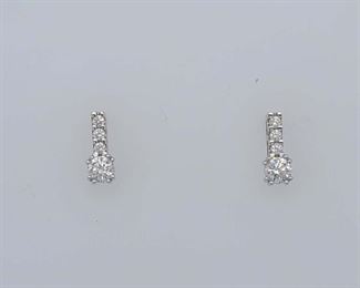 Very good condition. From Calhoun's: "One pair of 18kt white gold earrings (stamped E&E) containing the following stones: A) Two round brilliant-cut diamonds measuring 3.75mm each and weighing approximately .18cts each. B) Six round brilliant-cut diamonds measuring 1.7mm each and weighing .02cts each. Metal weight: 1.31 DWTS."
