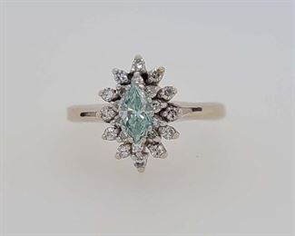 As pictured. From Calhoun's: "One lady's 14kt (stamped) white gold ring containing the following stones: A) One marquise-faceted diamond measuring 7.0x3.6mm and weighing approximately .42cts with an irradiated green color and clarity of SI1. Note: This diamond is chipped. B) Twelve round single-cut diamonds measuring 1.7mm each and weighing .02cts each with a color of F and clarity of VVS1. C) Ten round single-cut diamonds measuring 1.3mm each and weighing .01cts each with a color of F and clarity of VVS1. Finger size 8 1/2. Metal weight: 2.37 DWTs." Appraised for $3,600.00 in 2007 by a local jeweler, copy included with purchase. From appraisal: "One ladies white gold ring marked 14K, not trademarked. Set in center of ring is one Navet shaped .42 carat irradiated green diamond surrounded by ten .01 carat round single cut diamonds and twelve .02 carat round single cut diamonds for a total weight of .36 carat, grade 1."
