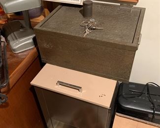 Vintage safe with key, another safe underneath it with a file drawer on top
