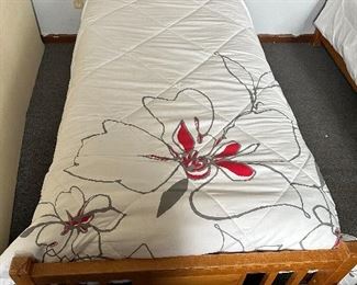 Pair of twin beds with box springs, mattresses and bedding