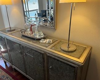 Modern silver and glass buffet, pair of modern lamps and large modern mirror