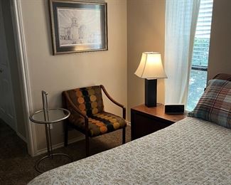 A pair of mid century modern chairs and silver tables and decor