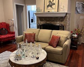 La z boy sleeper sofa round marble coffee table and woven rug