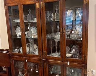 Beautiful lighted curio cabinet Asian modern design full of Chrystal and other glass pieces