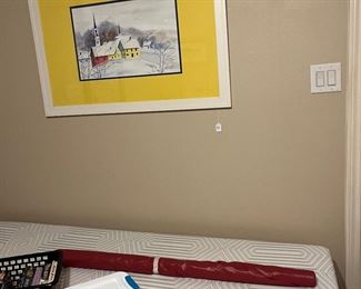 Twin bed and art tub is full of rail maps some vintage