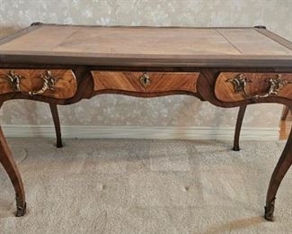 1.  $600.00. Partner's Desk.  French Louie XVI style with  leather top. Cast bronze ormolu.  A few slight finish issues due to its age and priced taking into consideration.   Otherwise it's beautiful. 
29" x 48" x 28"