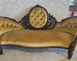 9.  $400.00. Belter style carved sofa. Mid  Victorian era w/medallion back. Button back with single attached cushion. 36" x 76" x 30" 