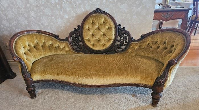 9.  $400.00. Belter style carved sofa. Mid  Victorian era w/medallion back. Button back with single attached cushion. 36" x 76" x 30" 