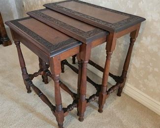 15.  $175.00. Nesting tables/set 3.  Tops are carved framing the border with block and turned legs and support stretchers.  Largest 24" x 24" x 11" 