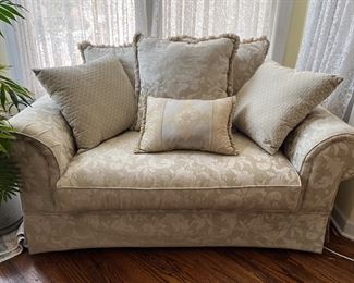 rolled arm loveseat with ivory upholstery 