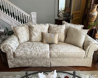 rolled arm sofa with ivory upholstery 