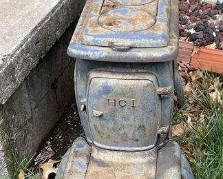 Antique cast iron wood-burning stove and an antique cast iron water pump