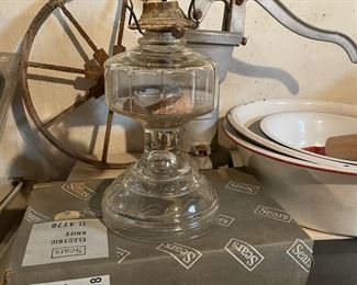 Antique cast iron water pump, glass oil lamp, and vintage Sears box