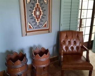 Two crown chimneys; one of pair of button tufted armchairs; a Navajo weaving