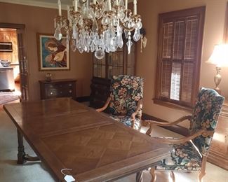 Large parquet dining table with leaves; two tapestry wooden armchairs; original angel painting