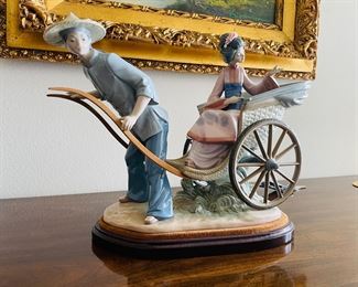 38_____$250 	
Lladro 1383 China lady in rikshaw 15x13x9 - missing finger -AS is 